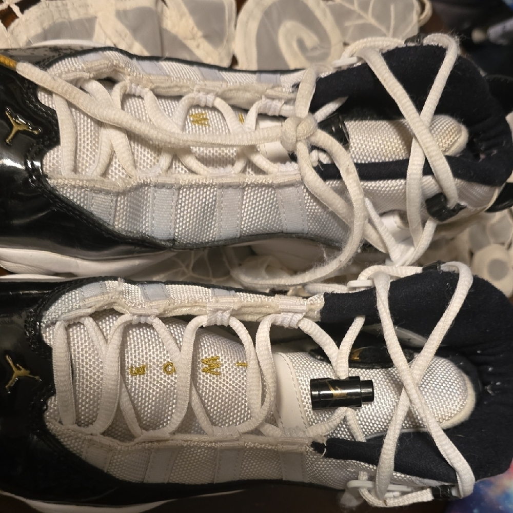 Stylish White and Black Sneakers with Gold Accent